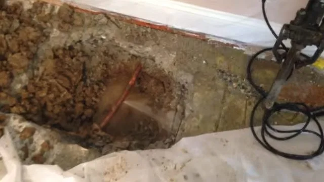 Acoustic sensor marking on brick floor, seen during leak detection service in Chino Valley, AZ.