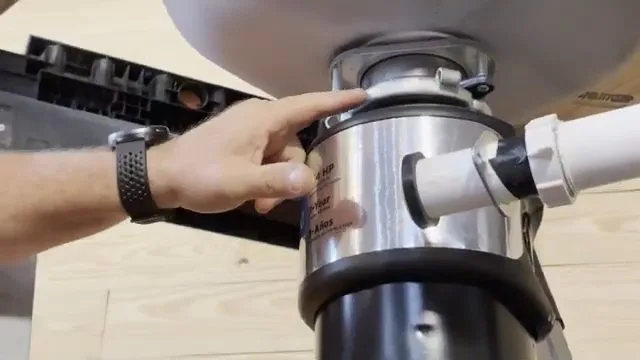 Aligning garbage disposal with sink flange, during garbage disposal work for a Chino Valley, AZ property.