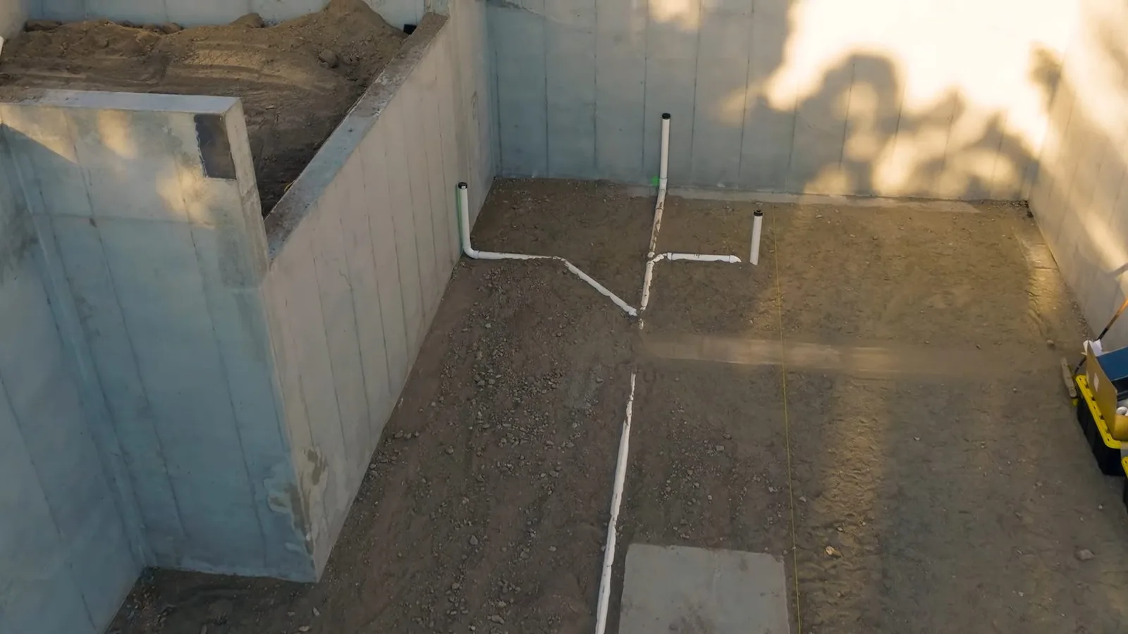 Basement drain lines beneath wood frame, photographed during drain cleaning work in Chino Valley, AZ.
