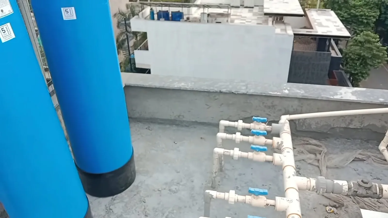 Blue water softener installed by wall, seen during water softener service in Chino Valley, AZ.