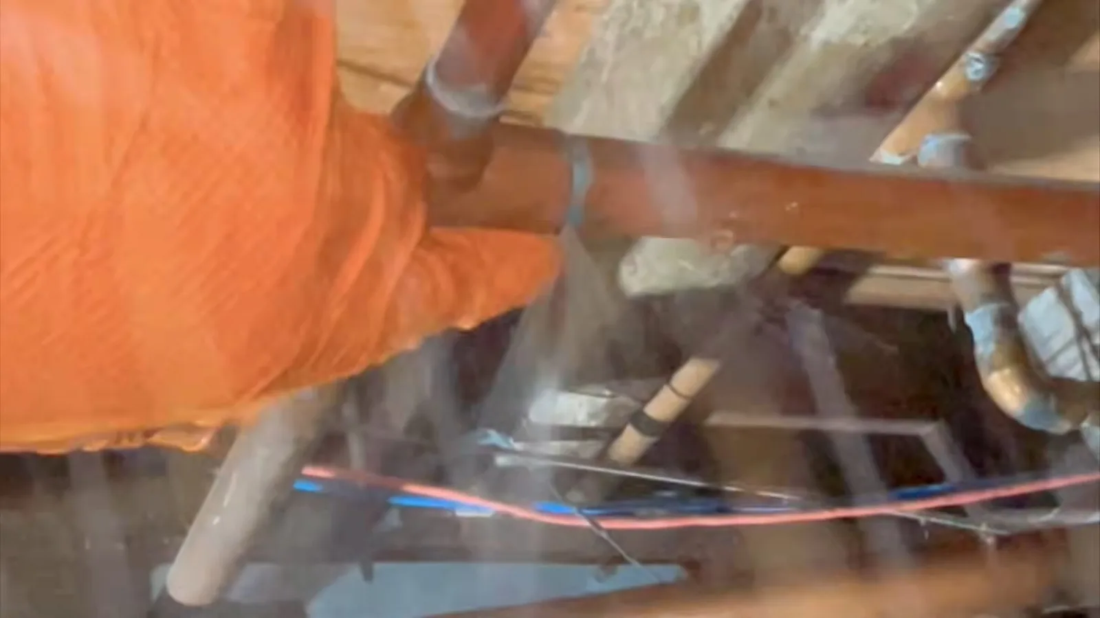 Broken crawlspace pipe under floor, seen during crawlspace plumbing service in Williamson Valley, AZ.