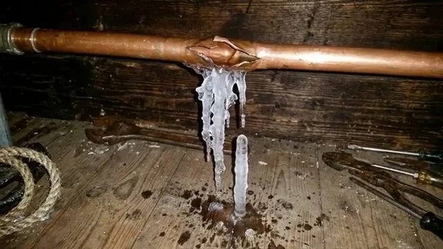 Burst copper pipe with hanging ice, photographed during frozen pipe work in Chino Valley, AZ.