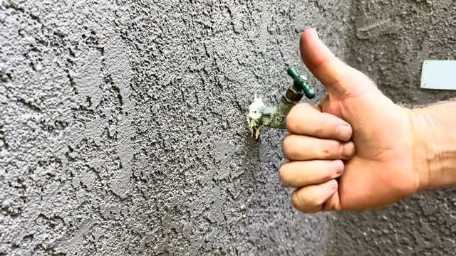 Checking hose bib handle after repair, seen during outdoor faucet repair service in Chino Valley, AZ.