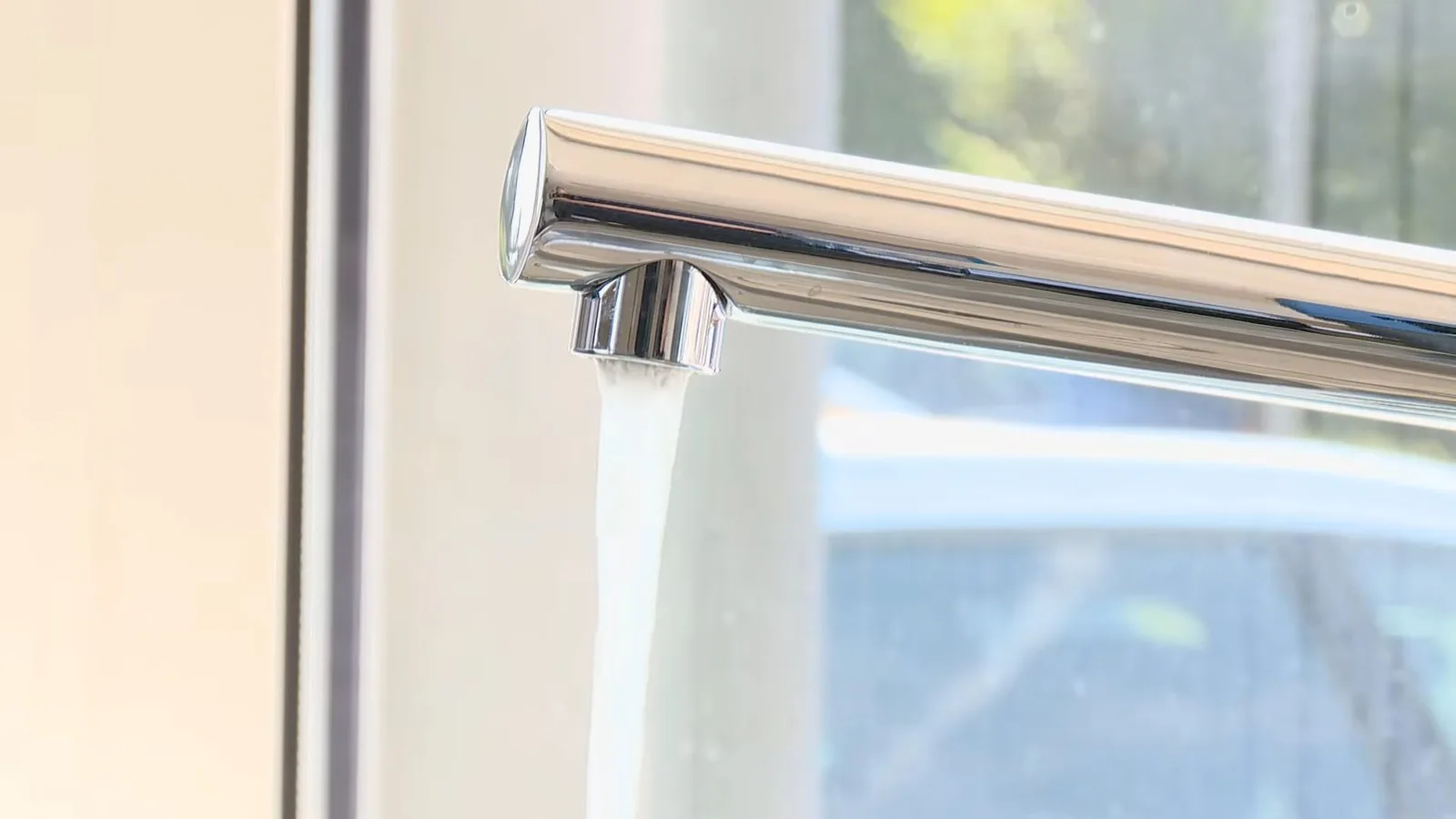Chrome kitchen faucet beside window, during faucet repair work for a Chino Valley, AZ property.