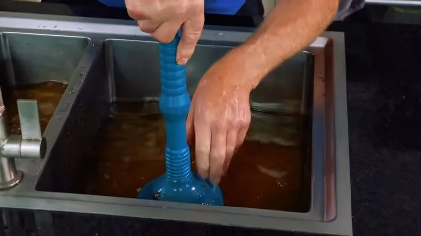 Clogged kitchen drain seen through strainer, seen during drain cleaning service in Chino Valley, AZ.