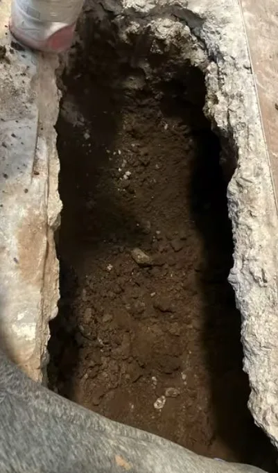Concrete slab trench beside pipe, during slab leak work for a Chino Valley, AZ property.