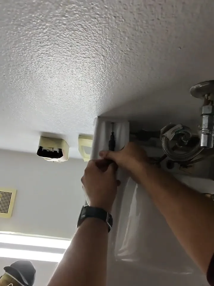 Contractor installing restroom ceiling drain, during a drain cleaning call in Chino Valley, AZ.