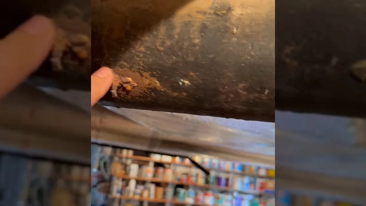 Corroded cast iron pipe inside crawlspace, seen during sewer repair service in Williamson Valley, AZ.
