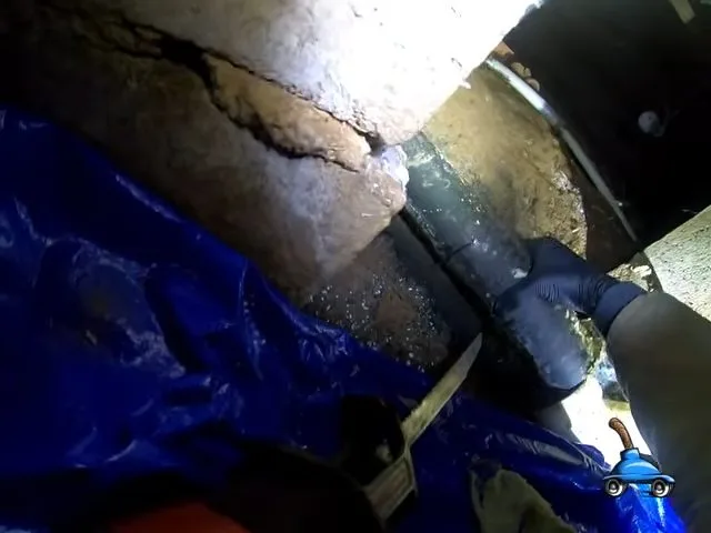 Cutting damaged crawlspace sewer pipe, during sewer line work for a Paulden, AZ property.