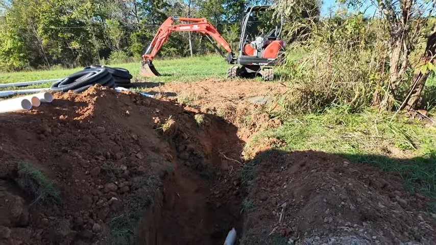 Excavator opening trench for septic pipe, captured on a sewer line job near Paulden, AZ.