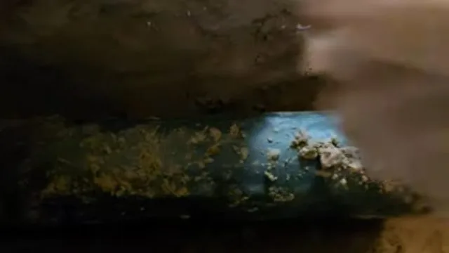 Exposed basement slab drain opening, photographed during slab leak work in Chino Valley, AZ.