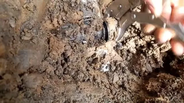 Exposed broken water line under muddy water, during water damage restoration work for a Chino Valley, AZ property.