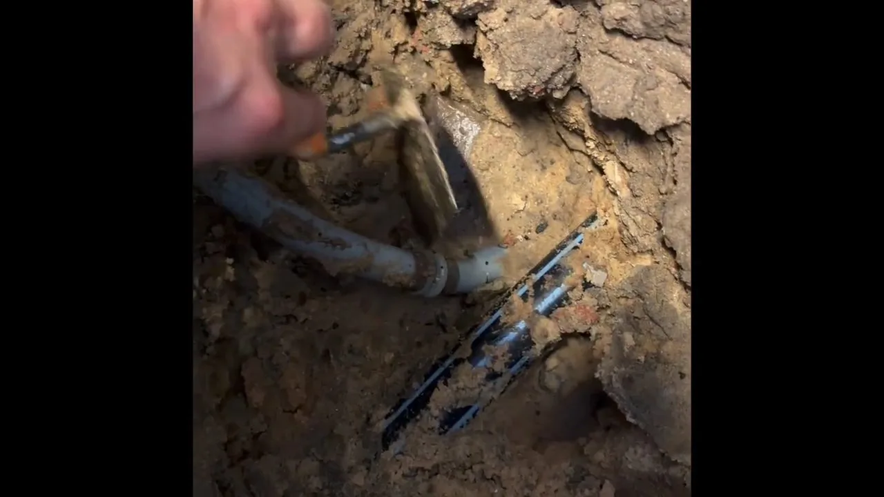 Exposed copper pipe beneath concrete, photographed during repiping work in Chino Valley, AZ.