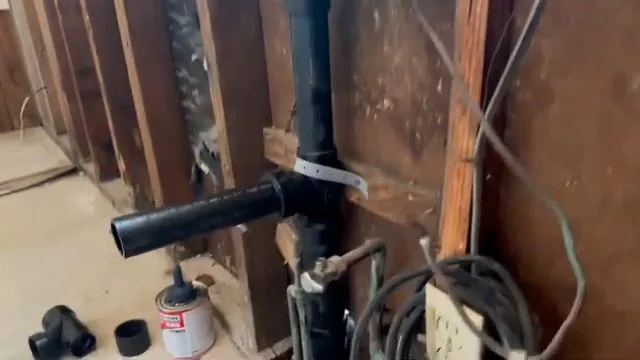 Exposed trenchless sewer pipe beneath floor, seen during sewer line service in Chino Valley, AZ.