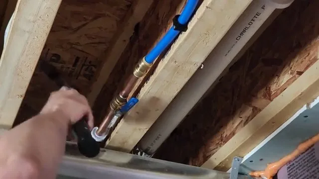 Installing blue and red pex lines in joists, captured on a repiping job near Chino Valley, AZ.