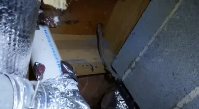 Measuring pipe clearance inside crawlspace, seen during crawlspace plumbing service in Chino Valley, AZ.