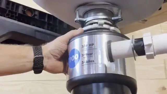 Mounting new garbage disposal under sink, seen during garbage disposal service in Chino Valley, AZ.