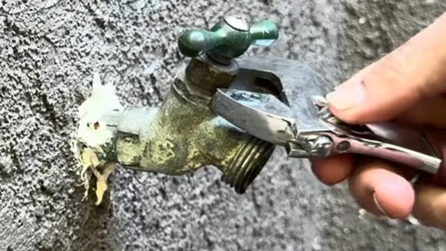 Opening leaking hose bib to diagnose drip, photographed during outdoor faucet repair work in Chino Valley, AZ.