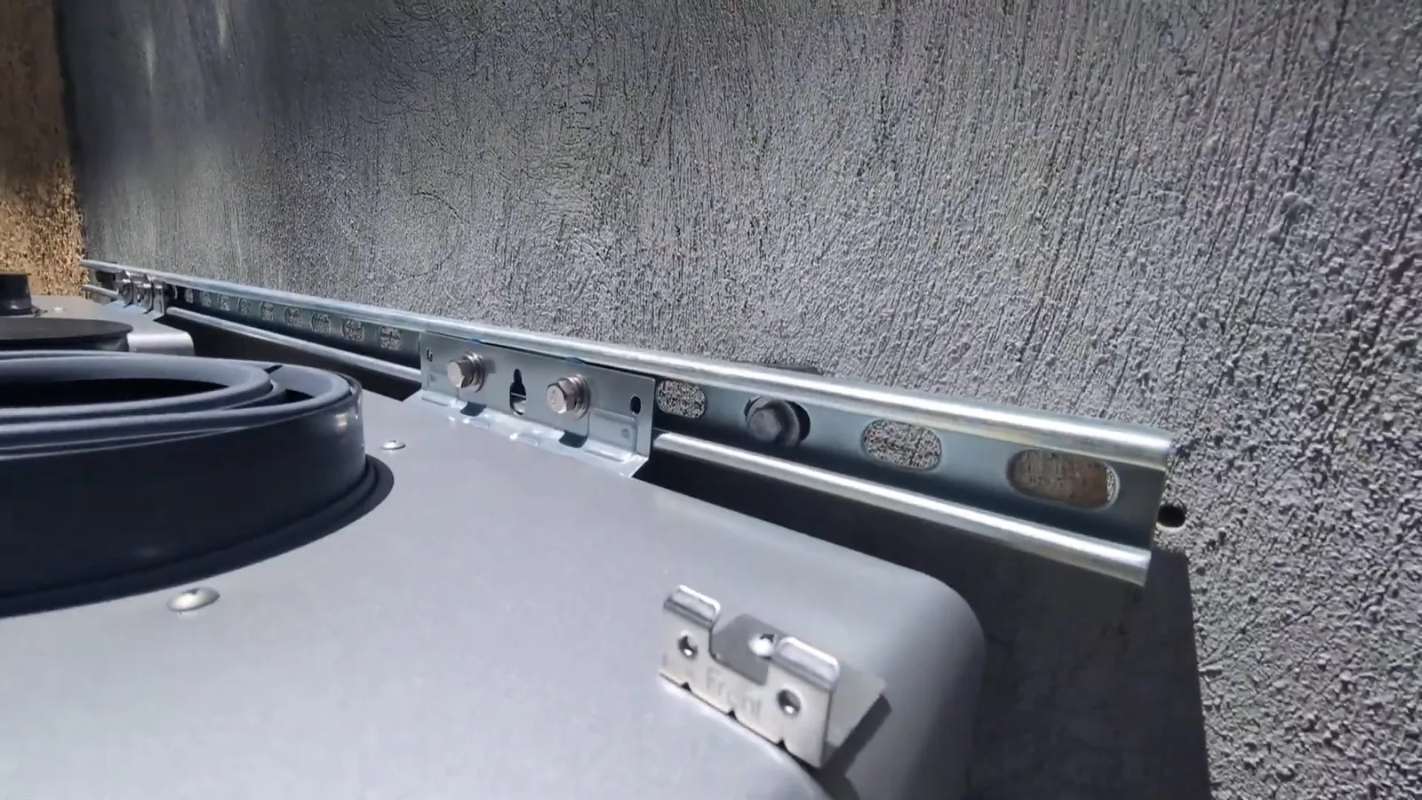 Outdoor tankless heater mounting bracket, seen during tankless water heater service in Chino Valley, AZ.