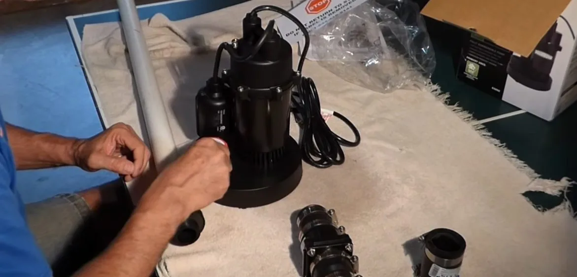 Sump pump components held before install, seen during sump pump service in Chino Valley, AZ.