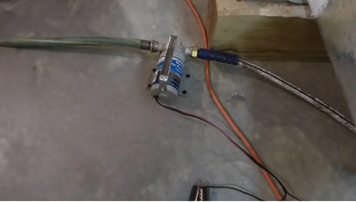Sump pump discharge pipe on basement floor, photographed during sump pump work in Chino Valley, AZ.