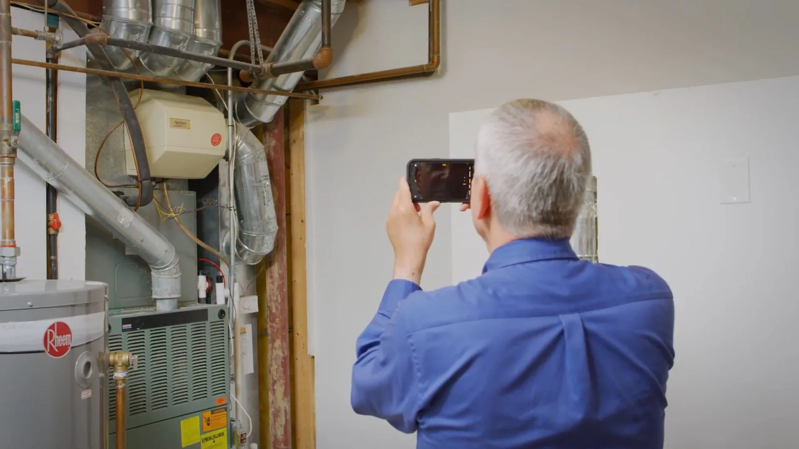 Technician inspecting existing water heater, during a water heater call in Chino Valley, AZ.