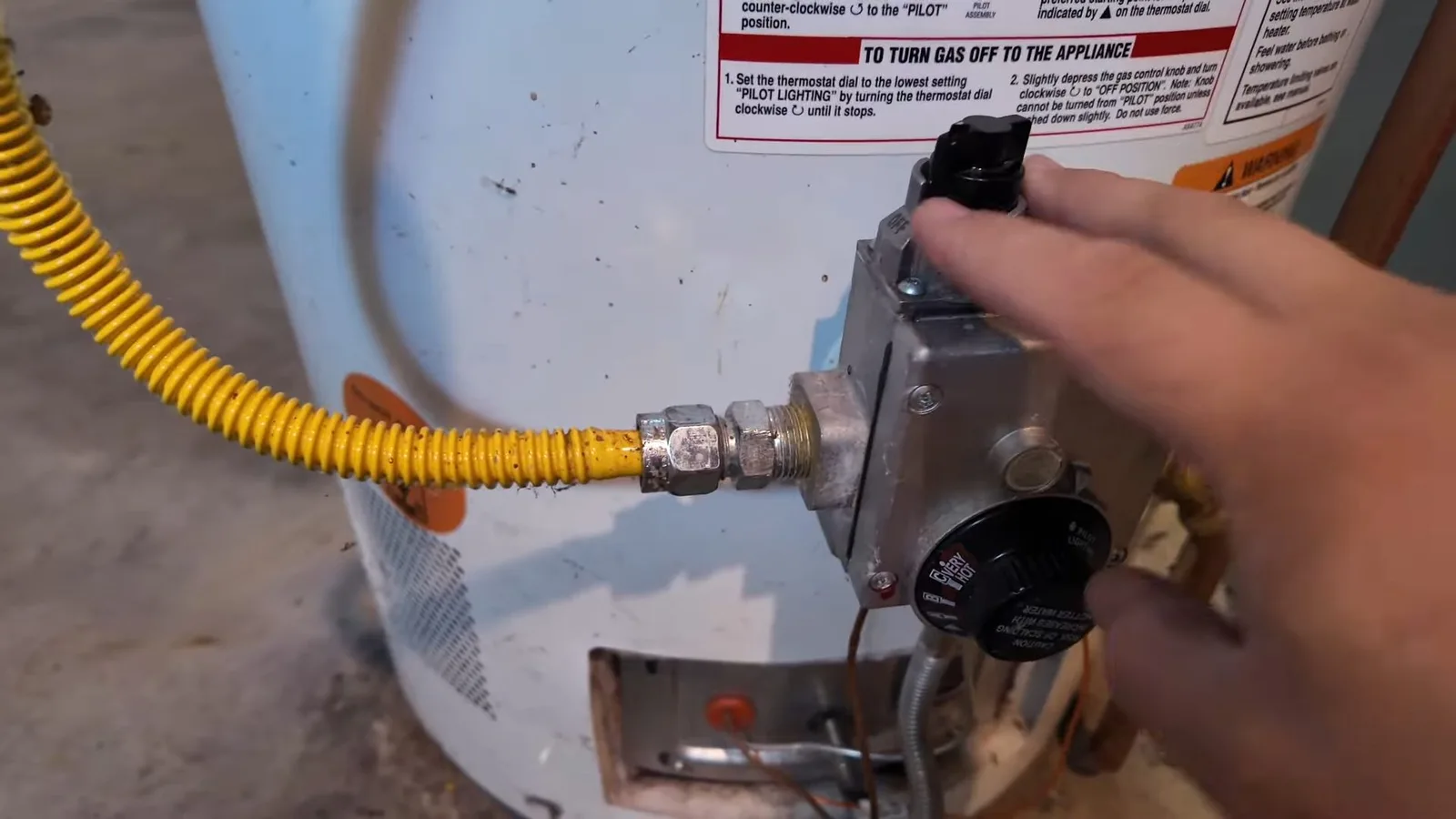 Technician turning gas valve on water heater, photographed during gas line work in Chino Valley, AZ.