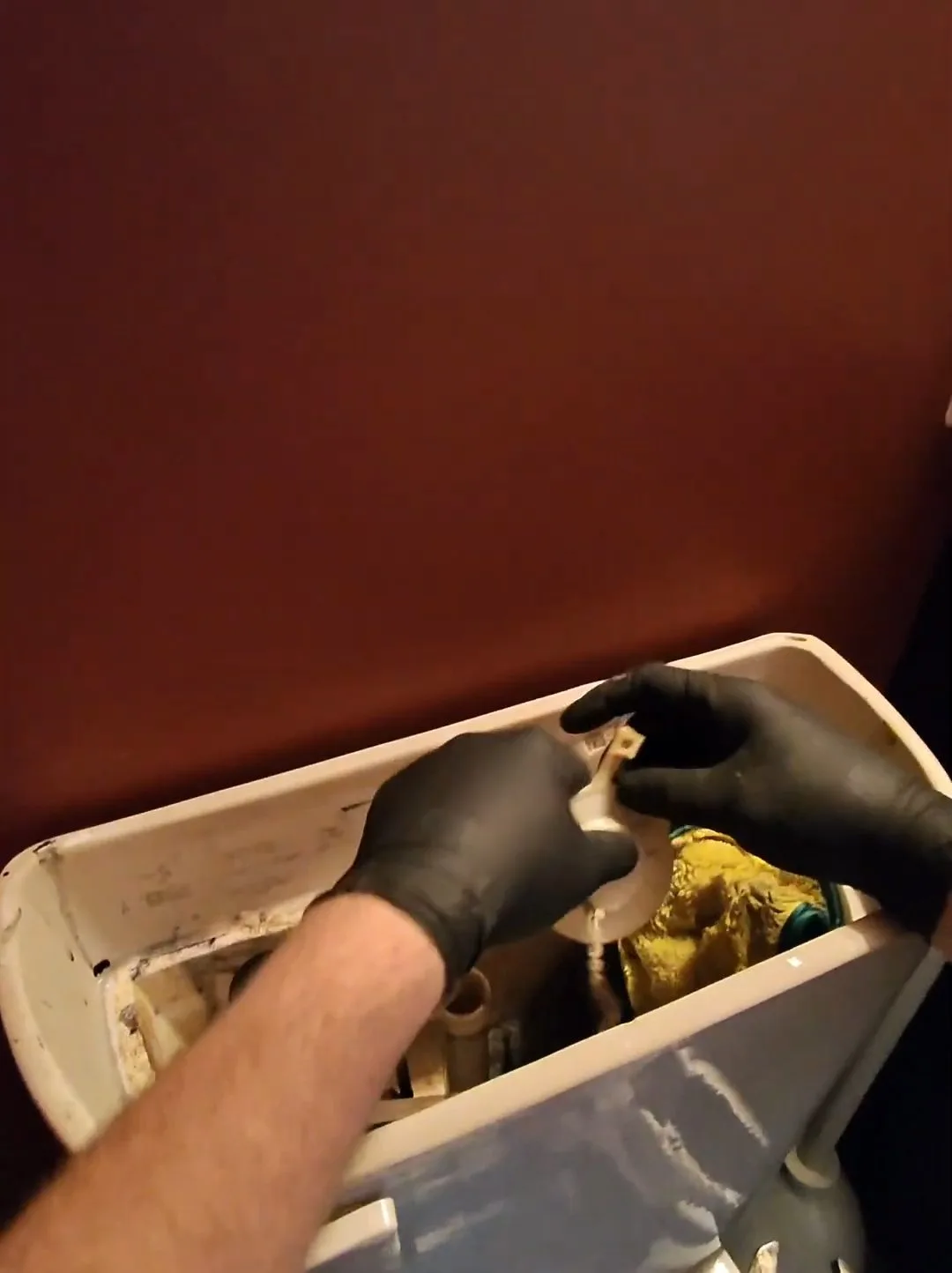 Toilet repair kit component in hand, captured on a toilet repair job near Chino Valley, AZ.