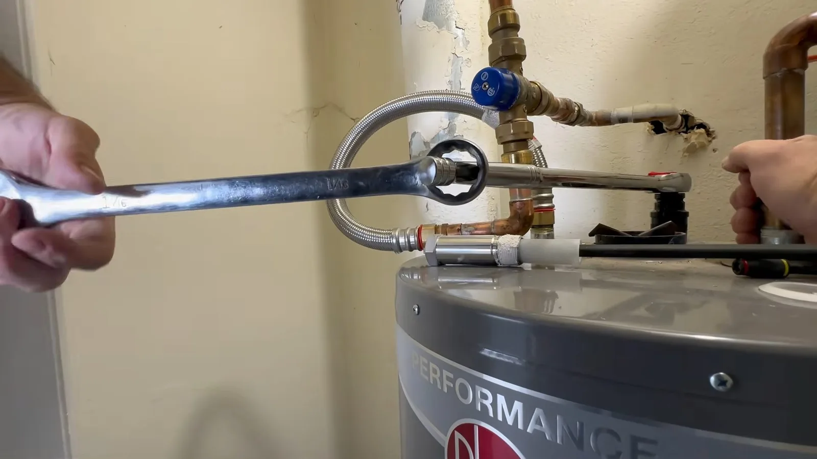 Water heater anode rod being loosened, seen during water heater service in Chino Valley, AZ.