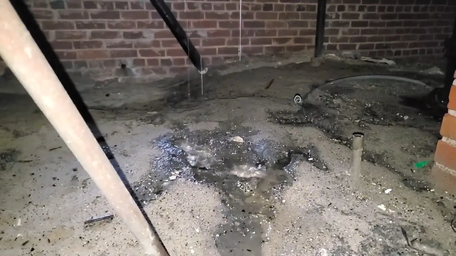 Wet ground under leaking crawlspace pipe, captured on a water damage restoration job near Chino Valley, AZ.
