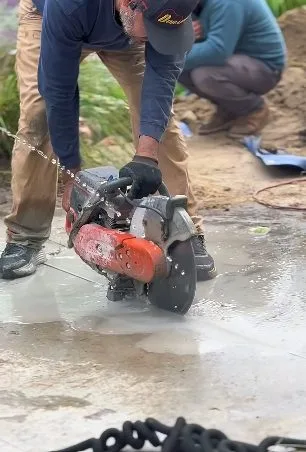 Worker cutting slab to repair leak, captured on a slab leak job near Chino Valley, AZ.